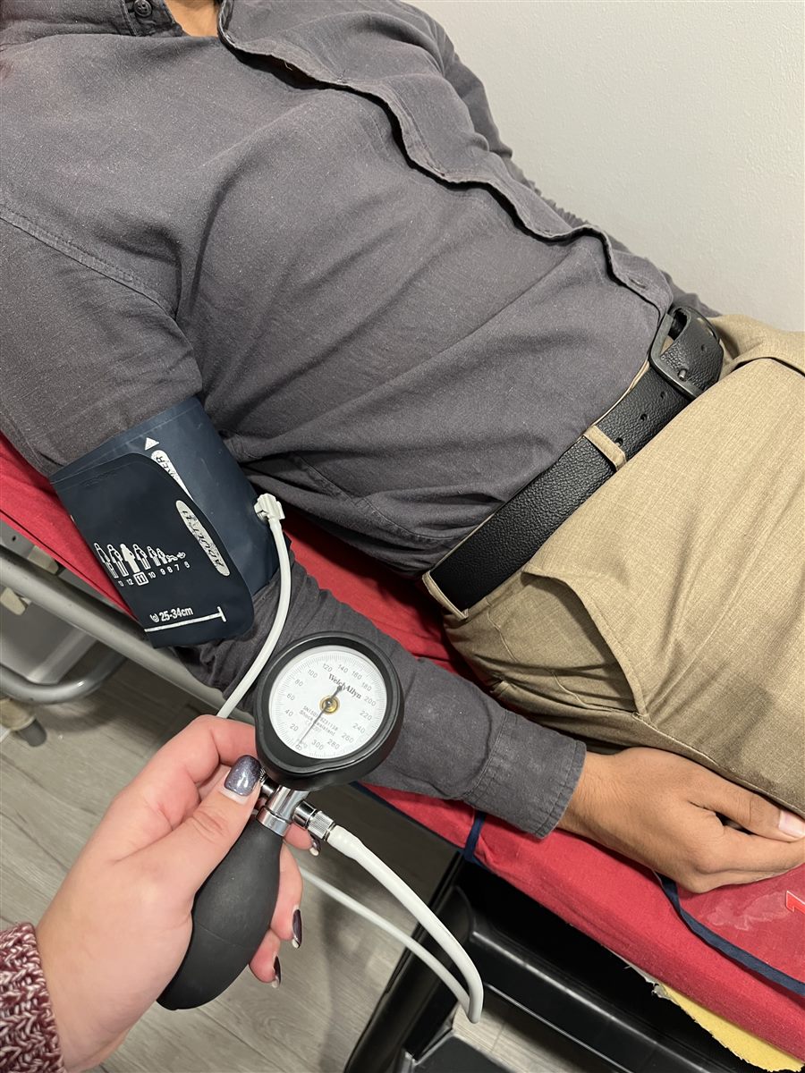 A doctor at Dr Mark van Niekerk & Associates taking a patient's blood pressure